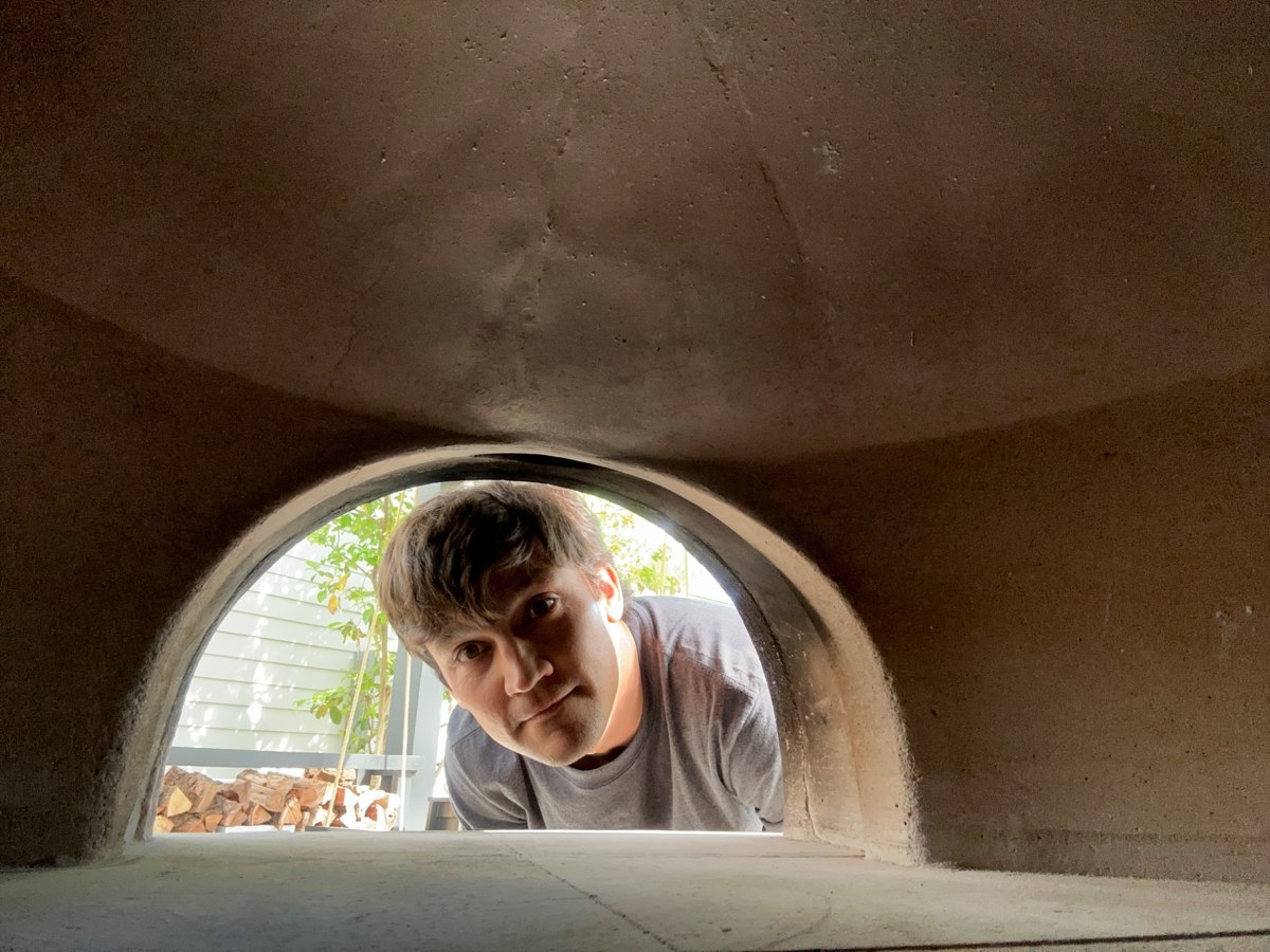 Patrick looking into his wood-fired bread oven